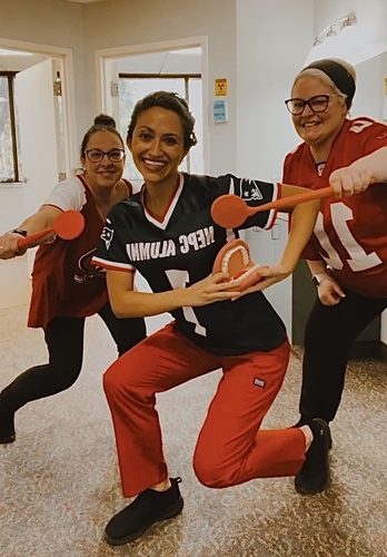 Photo of Dr. Muñoz dancing with staff