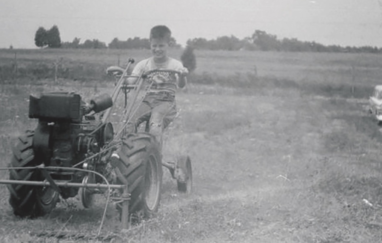 Dr. Shepley works a tractor in West Virginia